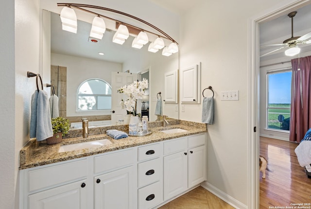 120 Seth Raynor, New Braunfels, TX 78130 - full bath with plenty of natural light, double vanity, ceiling fan, and wood finished floors