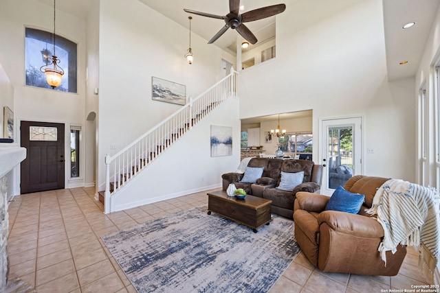 120 Seth Raynor, New Braunfels, TX 78130 - tiled living room with stairway, a towering ceiling, a chandelier, a ceiling fan, and baseboards