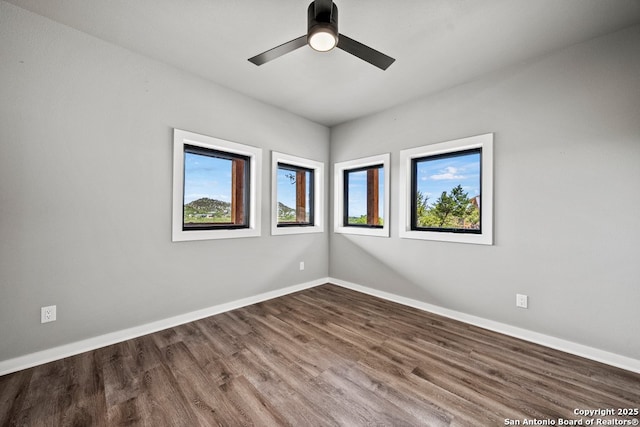 1053 Ledge Path, Canyon Lake, TX 78133 - unfurnished room featuring baseboards, wood finished floors, and a ceiling fan