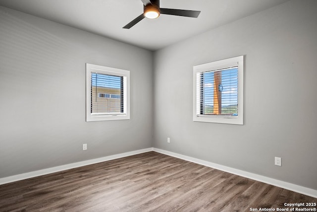 1053 Ledge Path, Canyon Lake, TX 78133 - unfurnished room featuring baseboards, wood finished floors, and a ceiling fan