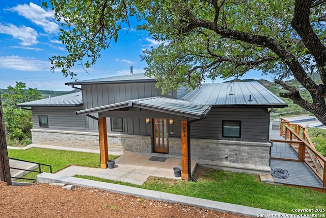 1053 Ledge Path, Canyon Lake, TX 78133 - view of front of property with stone siding, a front yard, and metal roof