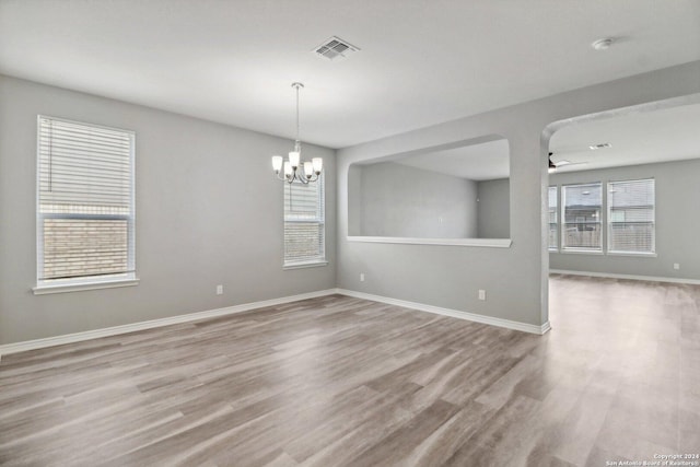15006 Tethys Way, San Antonio, TX 78245 - spare room with plenty of natural light, a chandelier, wood finished floors, and baseboards