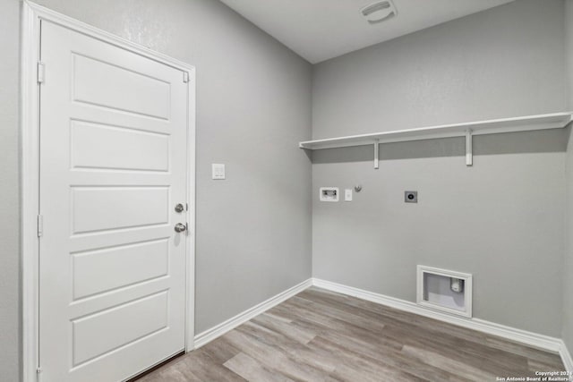 15006 Tethys Way, San Antonio, TX 78245 - laundry area with hookup for an electric dryer, gas dryer hookup, light wood-style floors, washer hookup, and baseboards