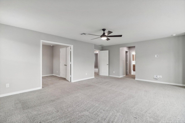 15006 Tethys Way, San Antonio, TX 78245 - unfurnished bedroom with light carpet, baseboards, ensuite bath, and ceiling fan