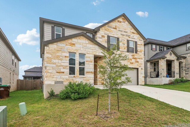 15006 Tethys Way, San Antonio, TX 78245 - view of front of home featuring stone siding, driveway, and an attached garage