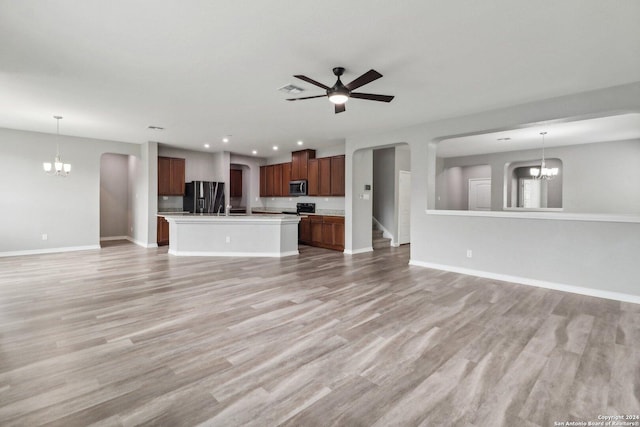 15006 Tethys Way, San Antonio, TX 78245 - unfurnished living room with a chandelier, baseboards, light wood-style floors, and recessed lighting