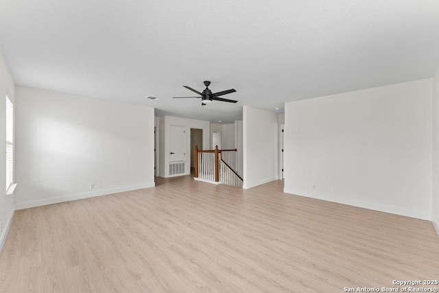8651 Eagle Peak, Helotes, TX 78023 - unfurnished living room featuring light wood-style flooring, baseboards, and ceiling fan
