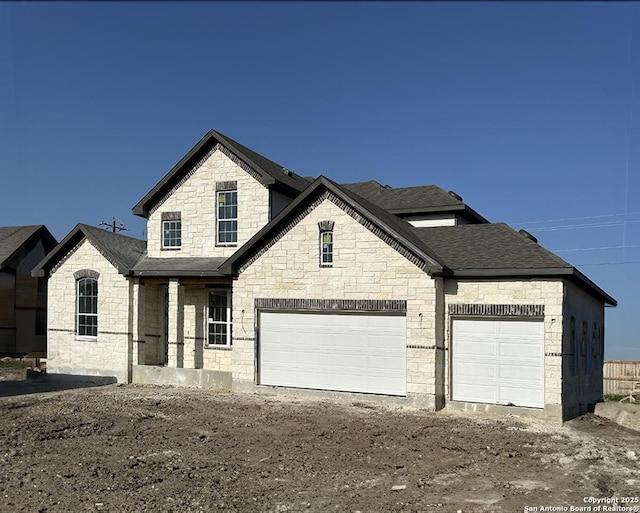 164 Annette Dr, Castroville, TX 78253 - french country inspired facade with stone siding, driveway, a shingled roof, and a garage