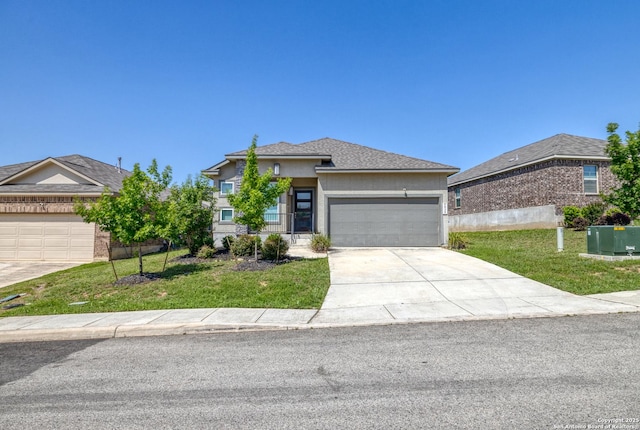 view of front of home with a front lawn, an attached garage, stucco siding, and driveway