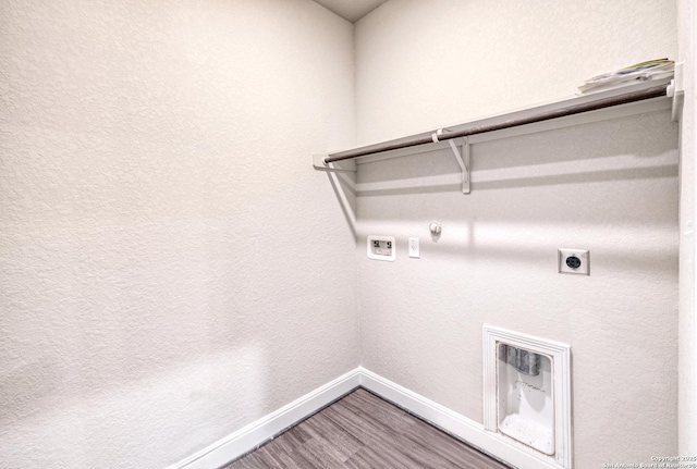 laundry area with gas dryer hookup, electric dryer hookup, washer hookup, baseboards, and wood finished floors