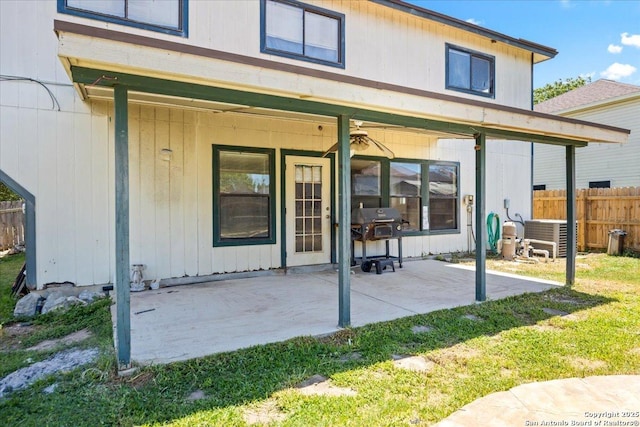 back of property featuring fence, a patio, and cooling unit
