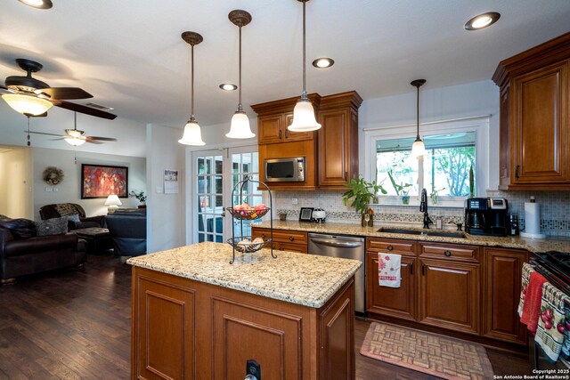 8423 Rolling Stone, San Antonio, TX 78254 - kitchen with appliances with stainless steel finishes, a sink, brown cabinets, decorative backsplash, and recessed lighting