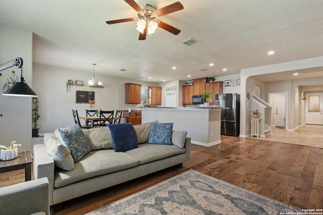 208 Cold Riv, Boerne, TX 78006 - living room with light wood-type flooring, a textured ceiling, recessed lighting, ceiling fan, and stairway