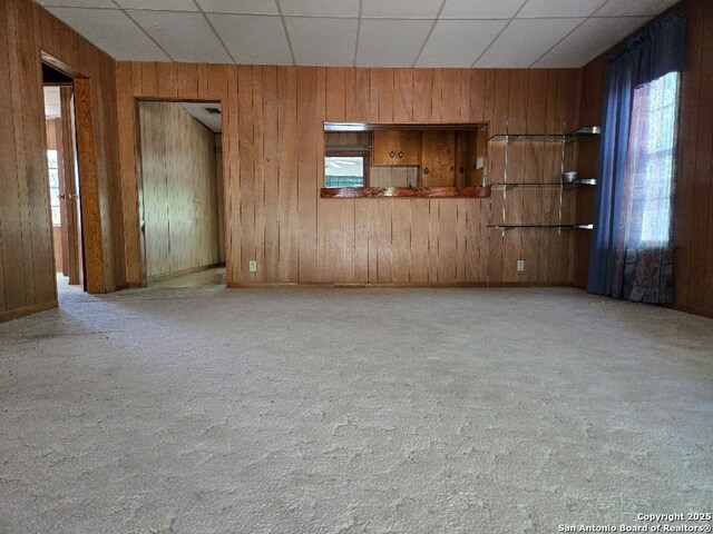 301 Ingram, Ingram, TX 78025 - unfurnished room featuring wood walls and carpet
