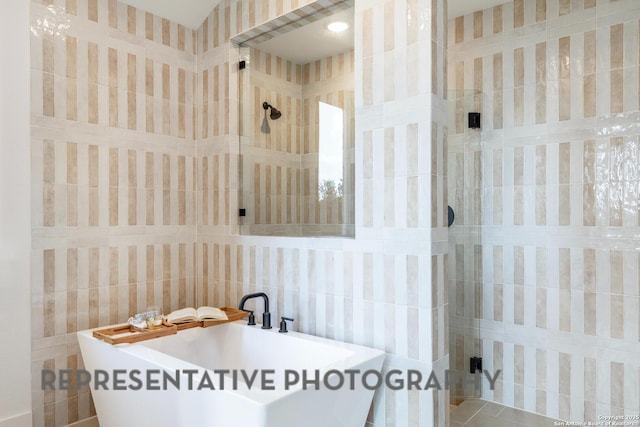 186 Lacey Oak, Castroville, TX 78009 - full bath featuring tile walls, a freestanding tub, and tiled shower