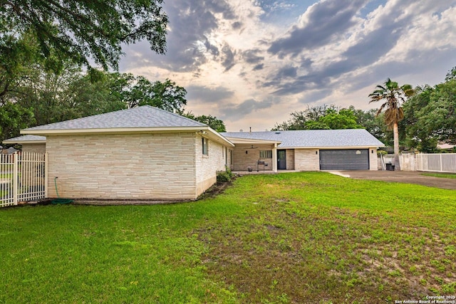 115 Wickford, Castle Hills, TX 78213 - rear view of property featuring driveway, an attached garage, and brick siding