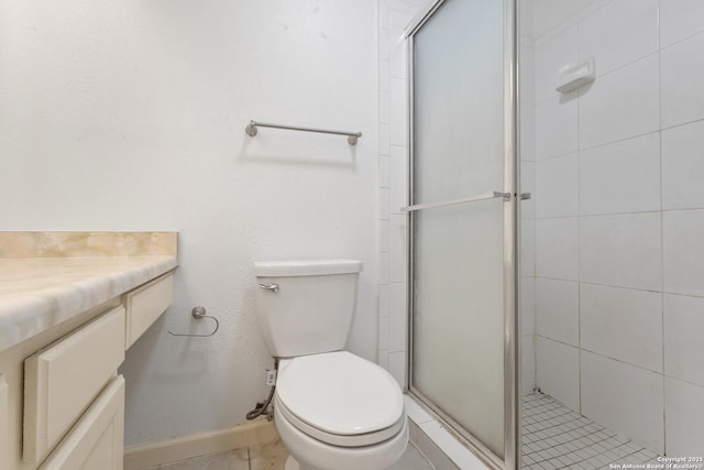 bathroom featuring a shower stall, toilet, baseboards, and tile patterned floors