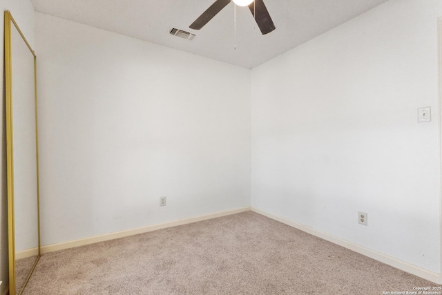carpeted empty room featuring ceiling fan and baseboards