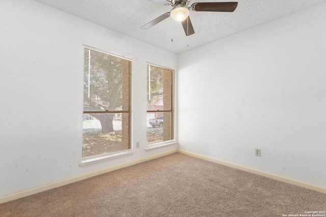 carpeted spare room with ceiling fan, a textured ceiling, and baseboards