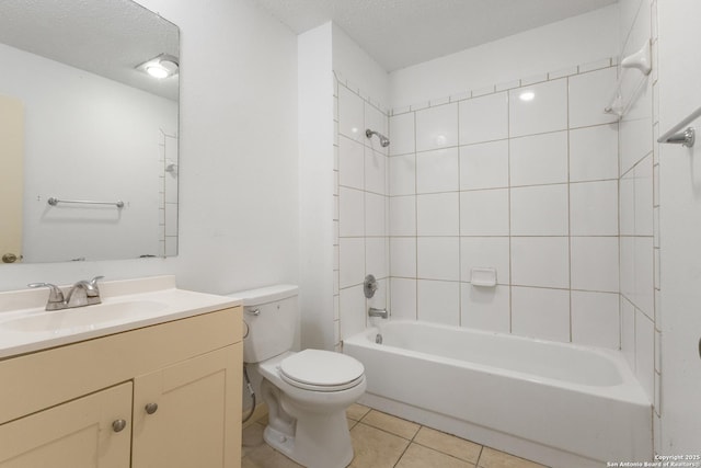 bathroom with tile patterned floors, toilet, bathtub / shower combination, vanity, and a textured ceiling