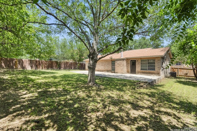 view of yard featuring a patio and central AC