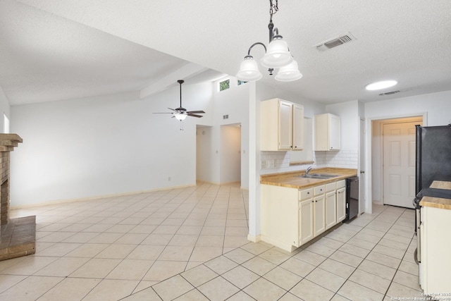 kitchen featuring a sink, light countertops, black appliances, backsplash, and a textured ceiling
