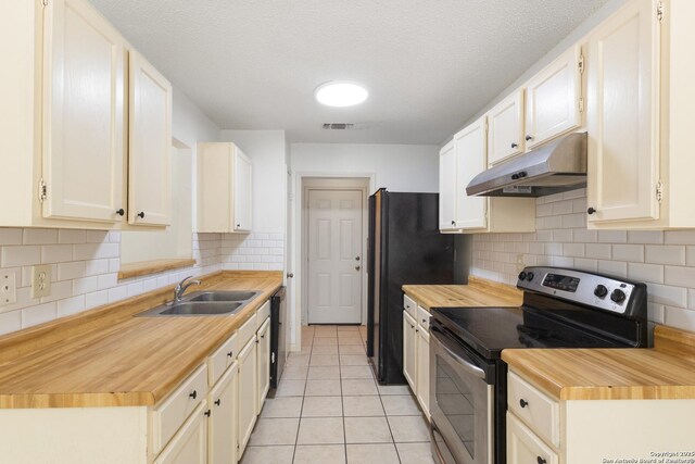 kitchen featuring stainless steel electric range, under cabinet range hood, a sink, wood counters, and dishwasher