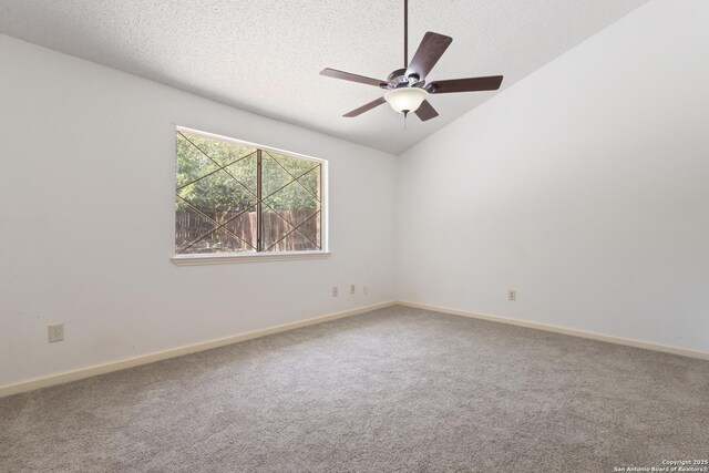 spare room featuring carpet, baseboards, ceiling fan, and a textured ceiling