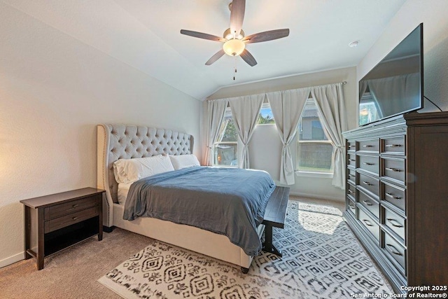 bedroom with light colored carpet, lofted ceiling, a ceiling fan, and baseboards