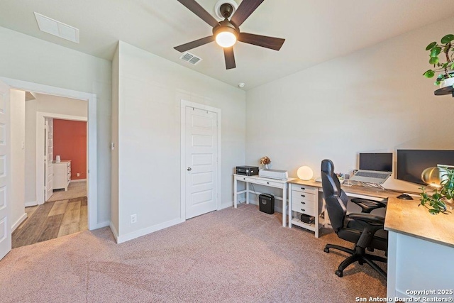 carpeted office featuring ceiling fan and baseboards