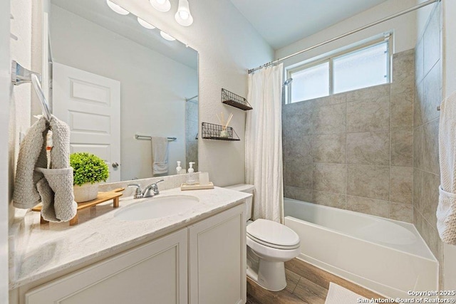 full bath with wood finished floors, toilet, shower / bath combo with shower curtain, and vanity