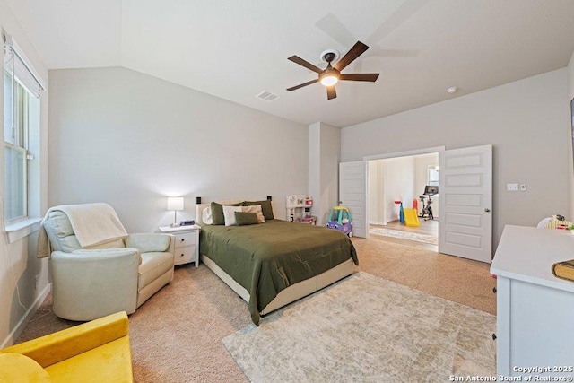 bedroom featuring light carpet, vaulted ceiling, and ceiling fan