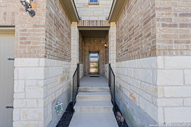 property entrance with brick siding