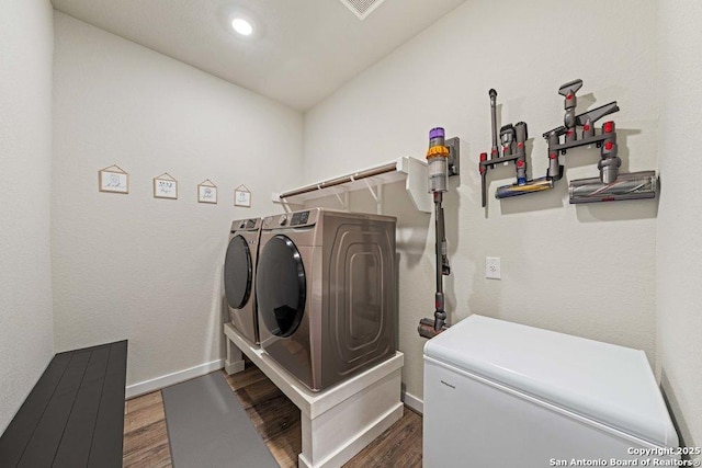 laundry area featuring separate washer and dryer, dark wood-style flooring, baseboards, and recessed lighting