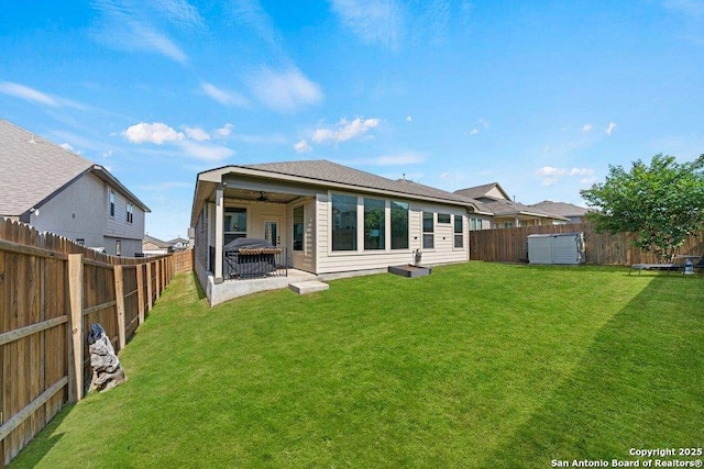 rear view of house with a patio area and a ceiling fan