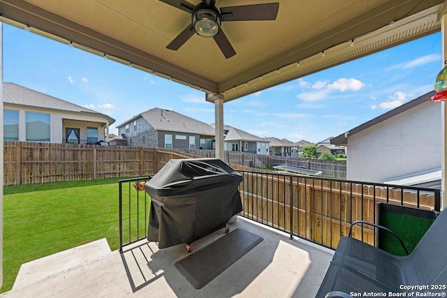 view of patio with a residential view and ceiling fan