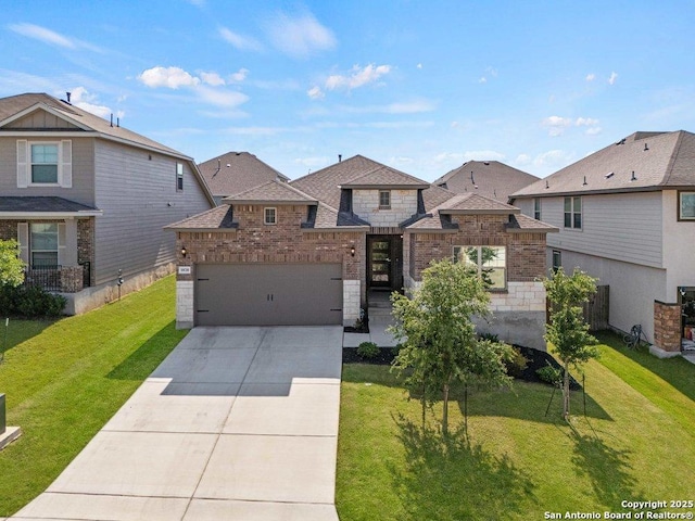 view of front facade with a garage, concrete driveway, a front yard, and stone siding