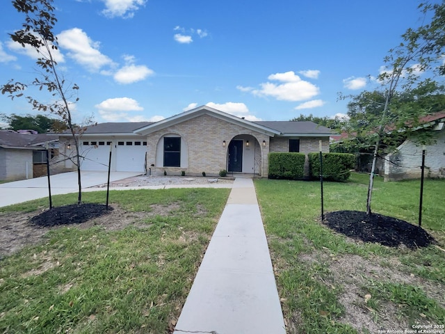 ranch-style home featuring a garage, brick siding, a front yard, and concrete driveway