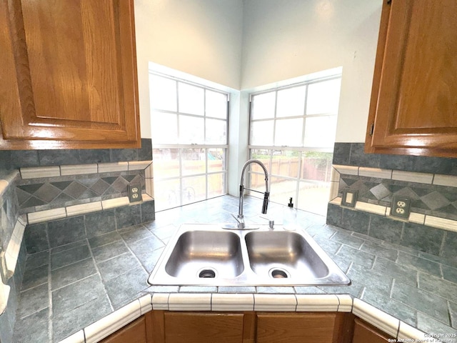 10511 Pemspice, San Antonio, TX 78240 - kitchen with a sink, brown cabinetry, backsplash, and tile countertops