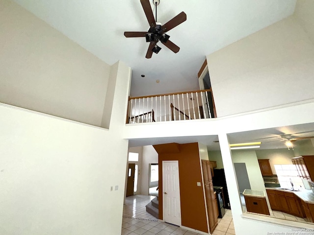 10511 Pemspice, San Antonio, TX 78240 - unfurnished living room featuring ceiling fan, a towering ceiling, and light tile patterned floors