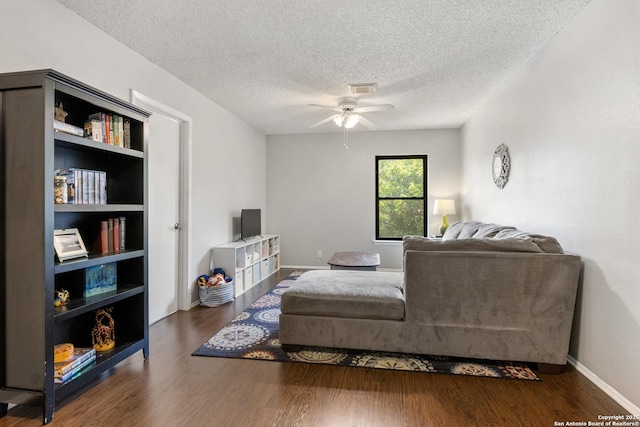 7705 Wood Blf, San Antonio, TX 78240 - living area with wood finished floors, a ceiling fan, a textured ceiling, and baseboards