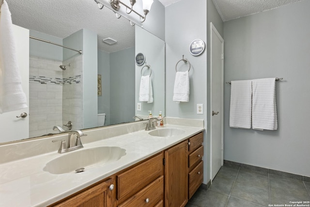 7705 Wood Blf, San Antonio, TX 78240 - full bath featuring a textured ceiling, toilet, a shower, double vanity, and tile patterned flooring