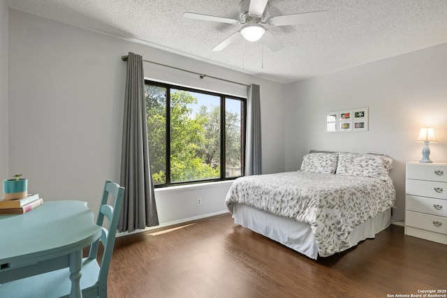 7705 Wood Blf, San Antonio, TX 78240 - bedroom with a textured ceiling, dark wood-style flooring, baseboards, and a ceiling fan