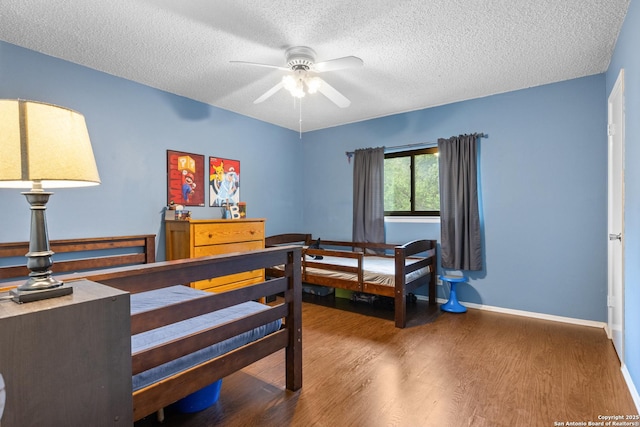 7705 Wood Blf, San Antonio, TX 78240 - bedroom featuring a textured ceiling, wood finished floors, and baseboards