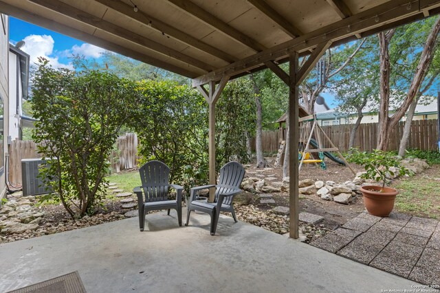 7705 Wood Blf, San Antonio, TX 78240 - view of patio with central AC, a playground, and a fenced backyard