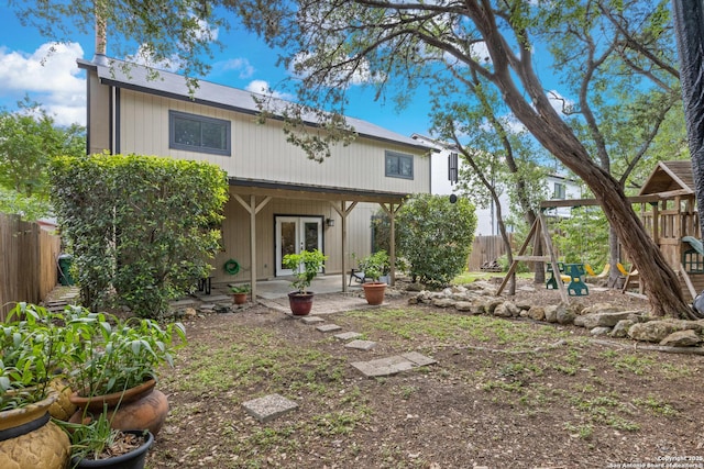 7705 Wood Blf, San Antonio, TX 78240 - back of property with french doors, a playground, fence, and a patio area