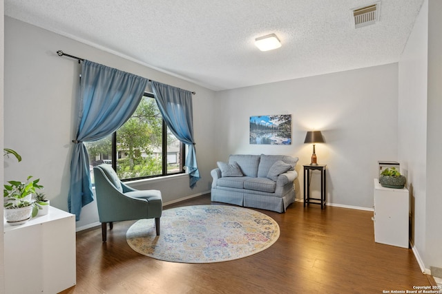7705 Wood Blf, San Antonio, TX 78240 - living area featuring wood finished floors, a textured ceiling, and baseboards