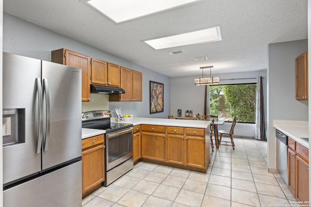 7705 Wood Blf, San Antonio, TX 78240 - kitchen featuring stainless steel appliances, under cabinet range hood, a peninsula, light countertops, and brown cabinetry