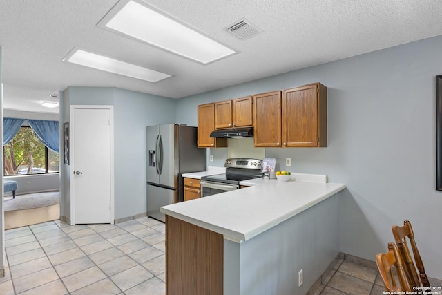 7705 Wood Blf, San Antonio, TX 78240 - kitchen featuring stainless steel appliances, under cabinet range hood, light countertops, brown cabinetry, and a peninsula