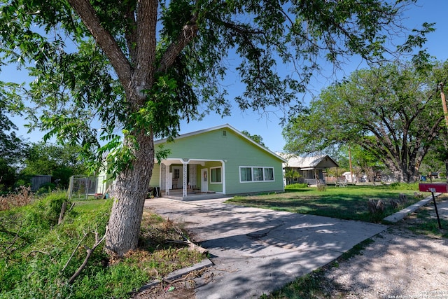 view of front of property with asphalt driveway and covered porch